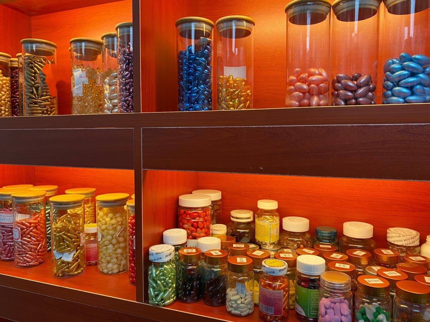 Softgels and capsules displayed in jars in the sample room